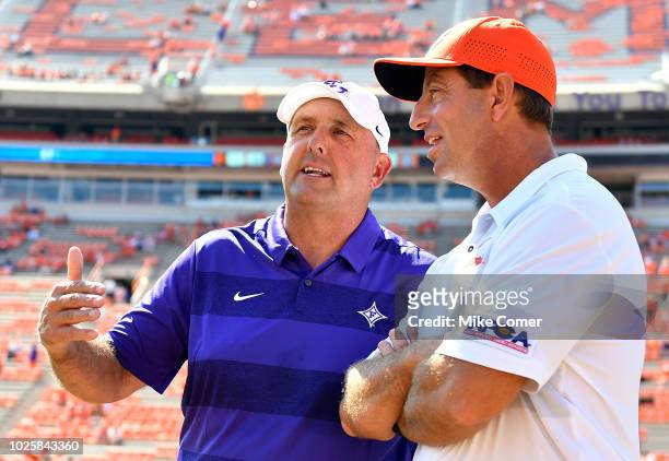 Head coach Dabo Swinney of the Clemson Tigers and head coach Clay Hendrix of the Furman Paladins talk at midfield prior to the start of their...