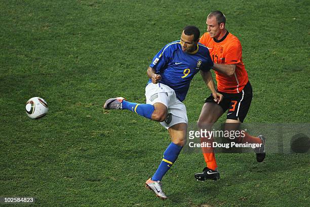 Luis Fabiano of Brazil attempts to control the ball under pressure from Andre Ooijer of the Netherlands during the 2010 FIFA World Cup South Africa...