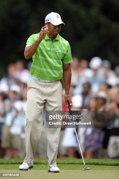 Tiger Woods reacts after he made a birdie putt on the third hole during the second round of the AT&T National at Aronimink Golf Club on July 2, 2010...