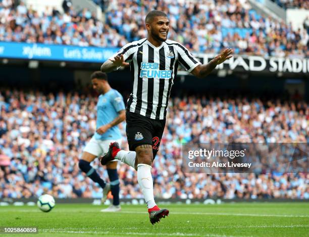 Deandre Yedlin of Newcastle United celebrates after scoring his team's first goal during the Premier League match between Manchester City and...