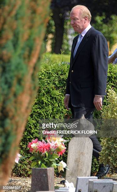 French Interior Minister Brice Hortefeux looks at a desecrated tombstone during a ceremony held in a cemetery where 17 Muslims tombstones were...