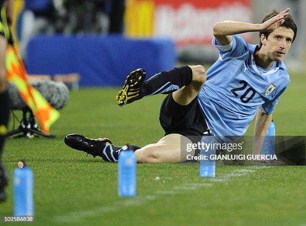 Uruguay's midfielder Alvaro Fernandez falls down in the sidelines during the quarter final 2010 World Cup match Uruguay versus Ghana on July 2, 2010...