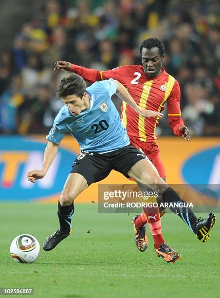 Uruguay's midfielder Alvaro Fernandez fights for the ball with Ghana's defender Hans Sarpei during the 2010 World Cup quarter-final match Uruguay vs....