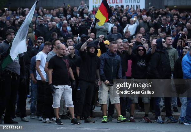 Participants in a right-wing march shout abuse at riot police after police halted the march due to a blockade by counter-demonstrators on September...