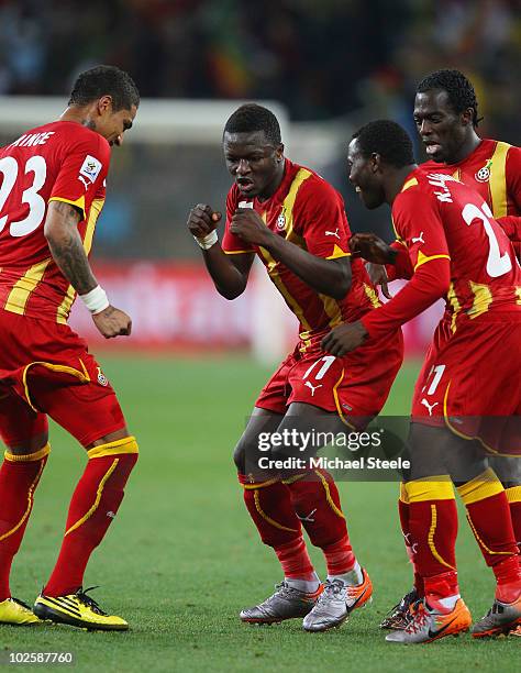 Sulley Muntari of Ghana celebrates scoring the opening goal with team mates during the 2010 FIFA World Cup South Africa Quarter Final match between...