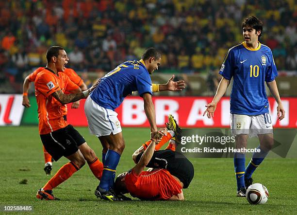 Felipe Melo of Brazil attempts to pull up to his feet the injured Arjen Robben of the Netherlands, Melo receives a red card and is sent off for the...