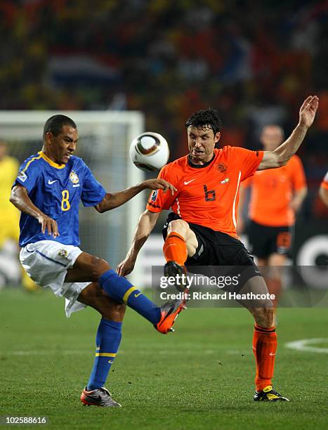 Mark Van Bommel of The Netherlands battles with Gilberto Silva of Brazil during the 2010 FIFA World Cup South Africa Quarter Final match between...