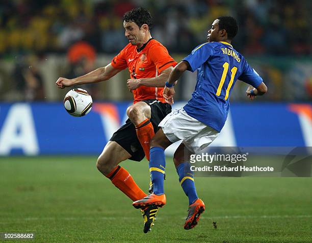 Mark Van Bommel of the Netherlands holds off Robinho of Brazil during the 2010 FIFA World Cup South Africa Quarter Final match between Netherlands...