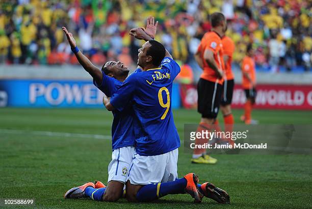 Luis Fabiano congratulates Robinho of Brazil after he scored the opening goal during the 2010 FIFA World Cup South Africa Quarter Final match between...