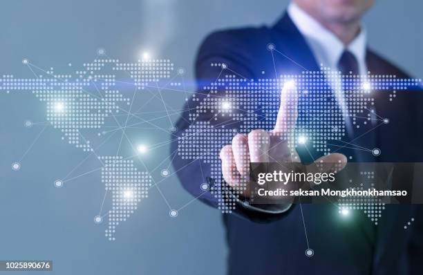 businessman operating virtual hud interface and manipulating elements with. - globe businessman stockfoto's en -beelden
