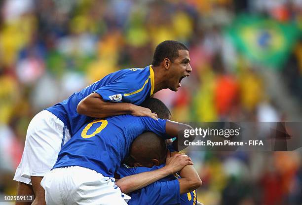 Felipe Melo of Brazil celebrates the opening goal scored by Robinho during the 2010 FIFA World Cup South Africa Quarter Final match between...