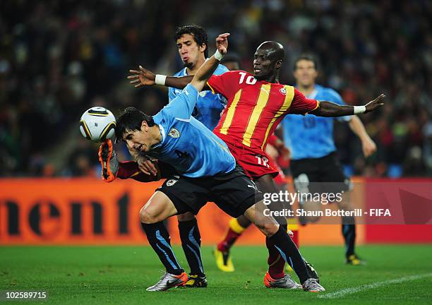 Stephen Appiah of Ghana tries to control the ball as Jorge Fucile of Uruguay attempts to head the ball during the 2010 FIFA World Cup South Africa...