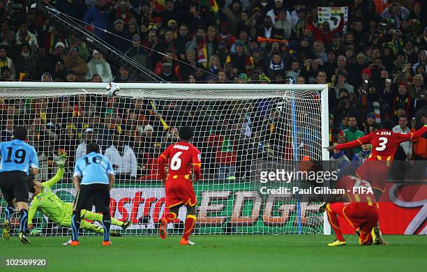 Asamoah Gyan of Ghana hits the penalty kick onto the crossbar after Luis Suarez of Uruguay handles the ball off the line and is sent off during the...