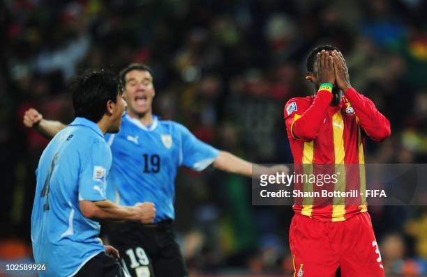Asamoah Gyan of Ghana covers his face in shock after he hits a penalty kick onto the crossbar after Luis Suarez of Uruguay handles the ball off the...