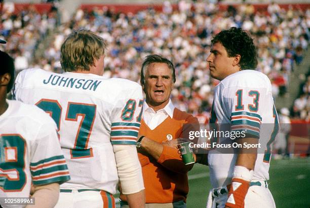 Head Coach Don Shula of the Miami Dolphins in this portrait on the sidelines talking with tight end Dan Johnson and quarterback Dan Marino circa mid...