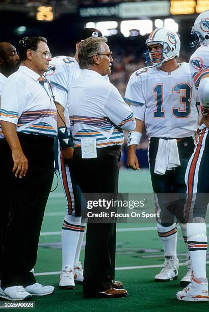 Head Coach Don Shula of the Miami Dolphins in this portrait on the sidelines talking with quarterback Dan Marino circa early 1990's during an NFL...