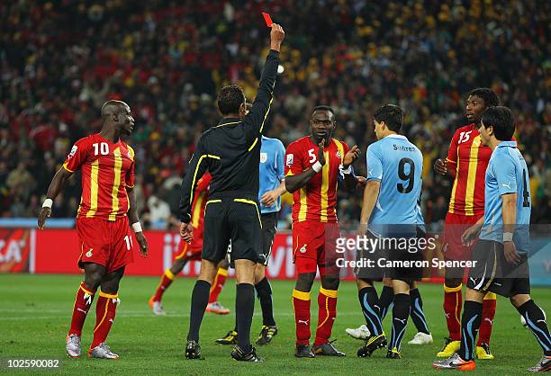 Luis Suarez of Uruguay is sent off by Referee Olegario Benquerenca after handling the ball on the goal line during the 2010 FIFA World Cup South...