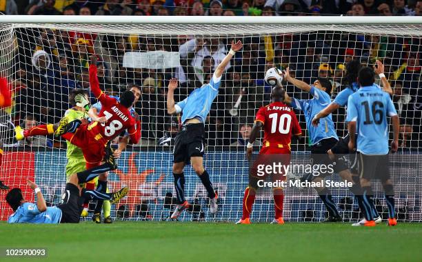 Luis Suarez of Uruguay handles the ball on the goal line, for which he is sent off, during the 2010 FIFA World Cup South Africa Quarter Final match...