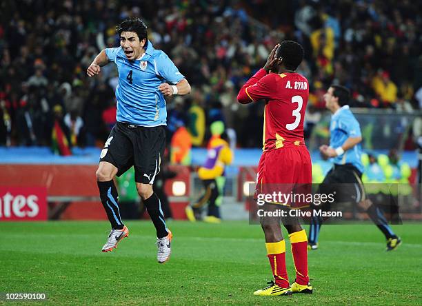 Jorge Fucile of Uruguay celebrates as Asamoah Gyan of Ghana misses a late penalty kick in extra time to win the match during the 2010 FIFA World Cup...
