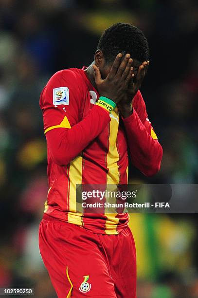 Asamoah Gyan of Ghana covers his face in shock after he hits a penalty kick onto the crossbar after Luis Suarez of Uruguay handles the ball off the...