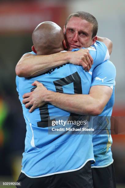 Diego Perez and Egidio Arevalo of Uruguay celebrate after winning a penalty shoot out during the 2010 FIFA World Cup South Africa Quarter Final match...