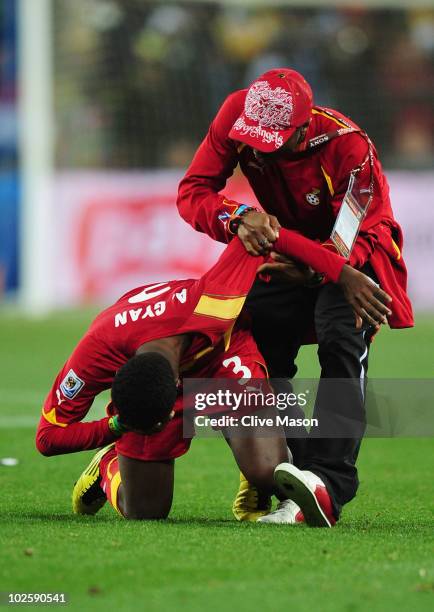 Asamoah Gyan of Ghana is consoled after his team are knocked out in a penalty shoot out during the 2010 FIFA World Cup South Africa Quarter Final...