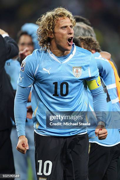 Diego Forlan of Uruguay celebrates victory after winning a penalty shoot out during the 2010 FIFA World Cup South Africa Quarter Final match between...