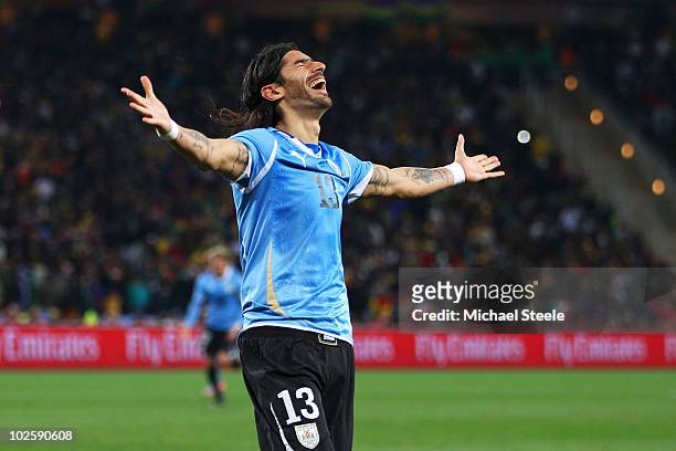 Sebastian Abreu of Uruguay celebrates scoring the winning penalty in a penalty shoot out during the 2010 FIFA World Cup South Africa Quarter Final...