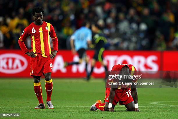 Anthony Annan and Stephen Appiah of Ghana show their dejection as they lose a penalty shoot out during the 2010 FIFA World Cup South Africa Quarter...
