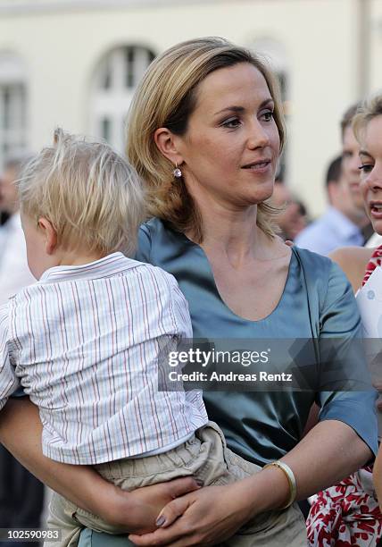 First Lady Bettina Wulff and her son Linus attend at the President's annual summer garden party at Schloss Bellevue presidential palace on July 2,...