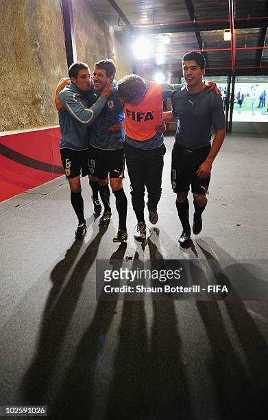 Sebastian Eguren, Andres Scotti, Diego Lugano and Luis Suarez of Uruguay celebrate winning the penalty shoot out and progress to the semi finals...