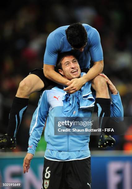 Luis Suarez and Sebastian Eguren of Uruguay celebrate winning the penalty shoot out and progress to the semi finals during the 2010 FIFA World Cup...