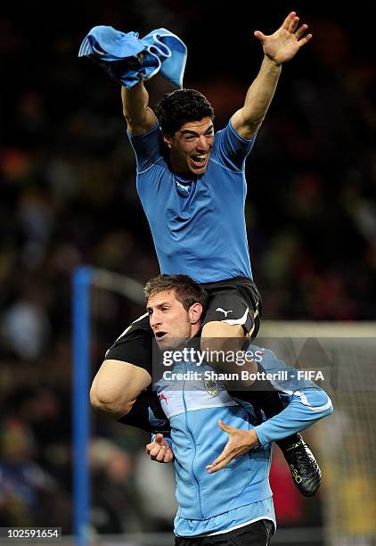 Luis Suarez and Sebastian Eguren of Uruguay celebrate winning the penalty shoot out and progress to the semi finals during the 2010 FIFA World Cup...