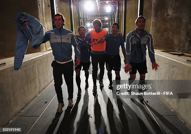 Andres Scotti, Diego Lugano, Luis Suarez and Sebastian Eguren of Uruguay celebrate winning the penalty shoot out and progress to the semi finals...