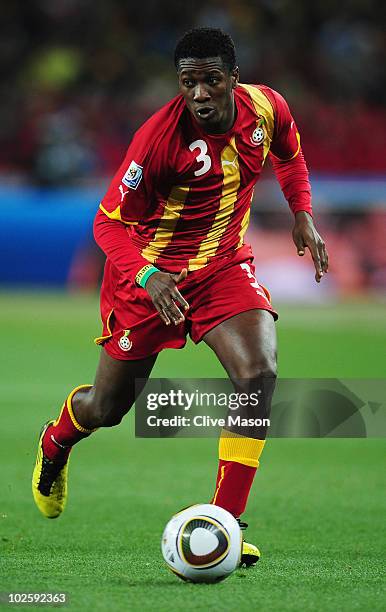Asamoah Gyan of Ghana runs with the ball during the 2010 FIFA World Cup South Africa Quarter Final match between Uruguay and Ghana at the Soccer City...