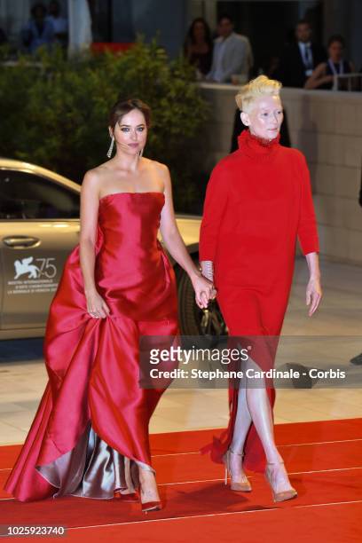 Actress Dakota Johnson and Tilda Swinton walk the red carpet ahead of the 'Suspiria' screening during the 75th Venice Film Festival at Sala Grande on...