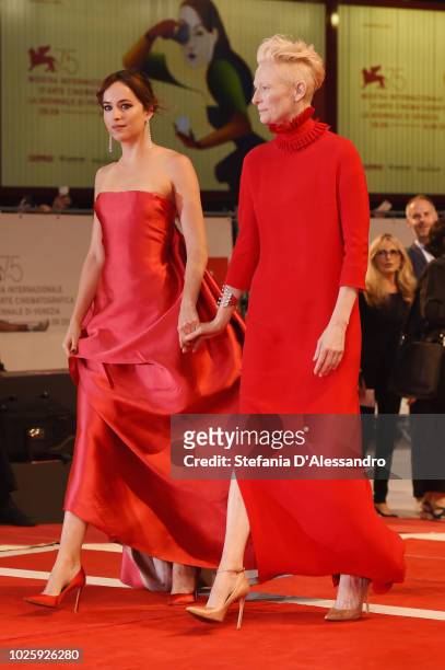 Dakota Johnson and Tilda Swinton walk the red carpet ahead of the 'Suspiria' screening during the 75th Venice Film Festival at Sala Grande on...