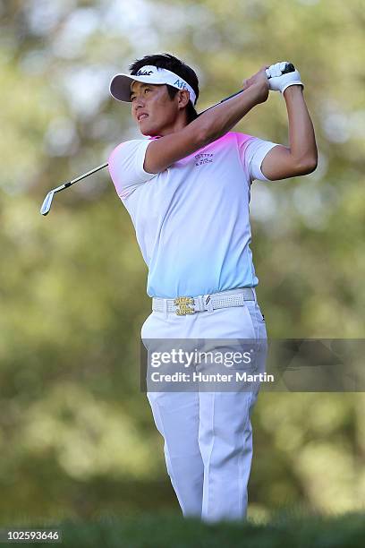 Ryuji Imada of Japan watches his tee shot on the 14th hole during the second round of the AT&T National at Aronimink Golf Club on July 2, 2010 in...