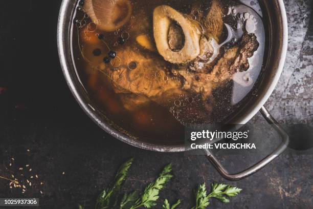 close up of clear beef bone meat broth with meat in cooking pot - beef stock photos et images de collection