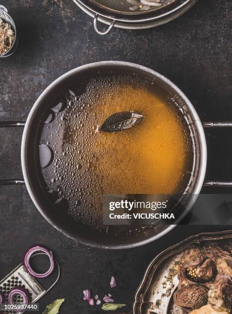 clear broth or stock without meat in cooking pot , close up - soup home foto e immagini stock