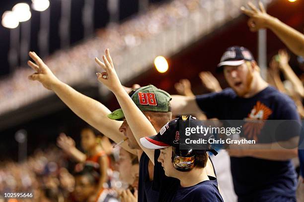 Fans hold up three fingers supporting Dale Earnhardt Jr., driver of the Wrangler Chevrolet during the NASCAR Nationwide Series Subway Jalapeno 250 at...