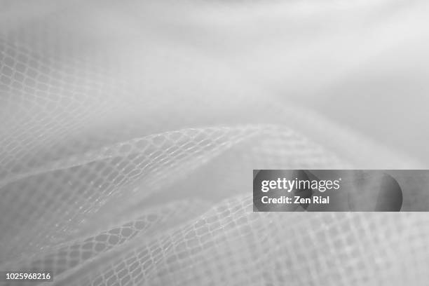 high key image of white tulle netting fabric - mesh texture stockfoto's en -beelden