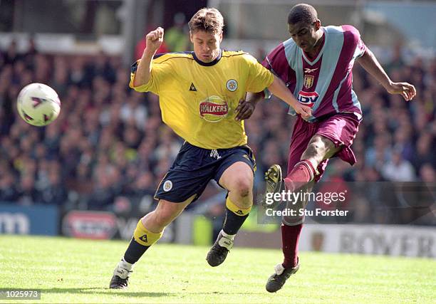 Lloyd Samuel of Aston Villa battles with Tony Cottee of Leicester City during the FA Carling Premier League match played at Villa Park in Birmingham....