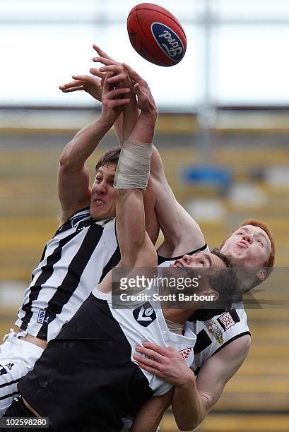 Corey Jones of North Ballarat and Tom Young of Collingwood compete for the ball during the round 11 VFL match between Collingwood and North Ballarat...