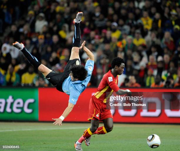 Jorge Fucile of Uruguay in mid air following a high challenge with Samuel Inkoom of Ghana during the 2010 FIFA World Cup South Africa Quarter Final...