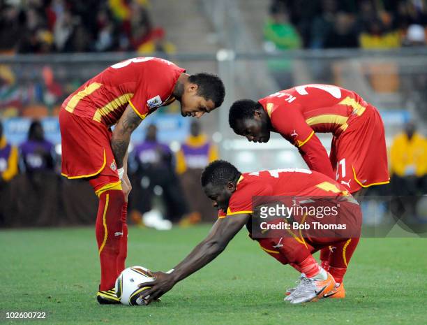 Sulley Muntari of Ghana places the ball for a penalty, watched by team-mates Kwandwo Asamoah and Kevin Prince Boateng during the 2010 FIFA World Cup...
