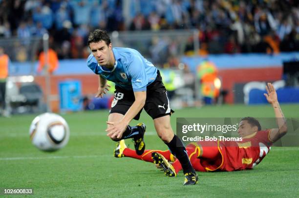 Andres Scotti of Uruguay and Kevin-Prince Boateng of Ghana in action during the 2010 FIFA World Cup South Africa Quarter Final match between Uruguay...