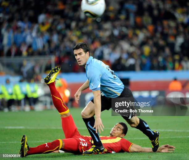Andres Scotti of Uruguay and Kevin-Prince Boateng of Ghana in action during the 2010 FIFA World Cup South Africa Quarter Final match between Uruguay...