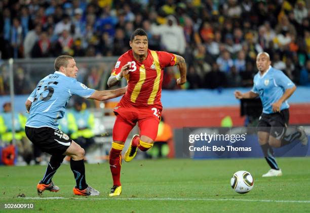 Kevin-Prince Boateng of Ghana moves past Diego Perez of Uruguay during the 2010 FIFA World Cup South Africa Quarter Final match between Uruguay and...