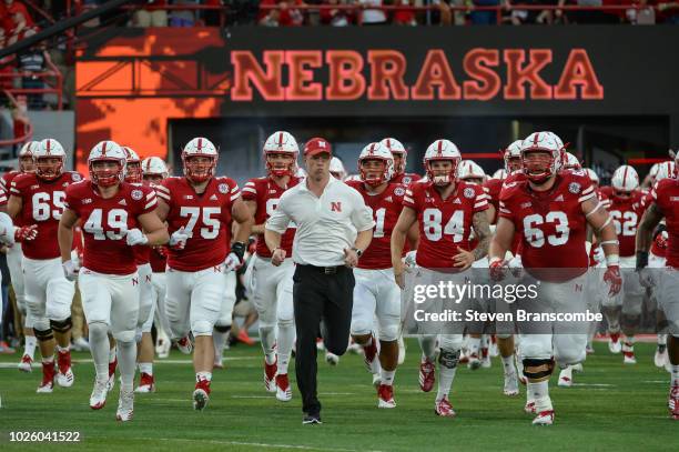 Head coach Scott Frost of the Nebraska Cornhuskers leads the team on the field before the game against the Akron Zips at Memorial Stadium on...